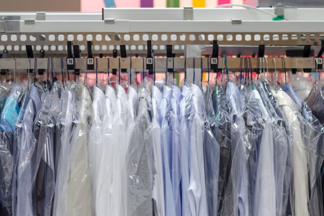 clothes in plastic bags at a dry cleaner
