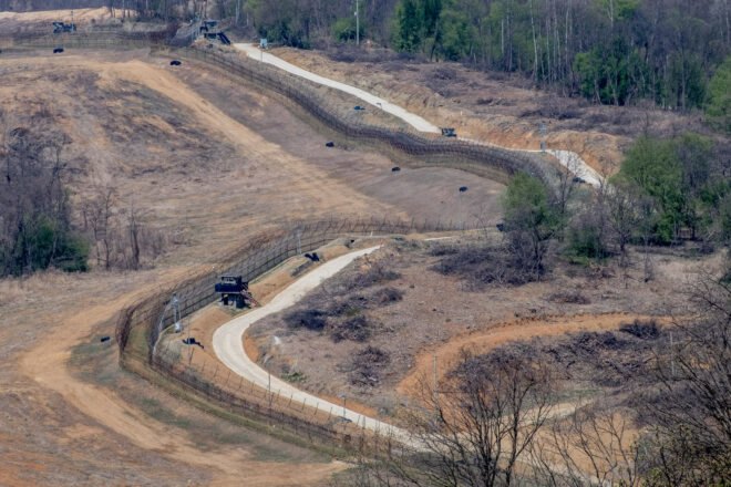 Korean DMZ zone with barbed wire and fences protecting empty land