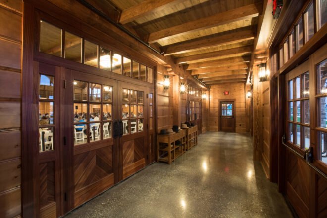 hallway lined in wooden panels and ceiling beams