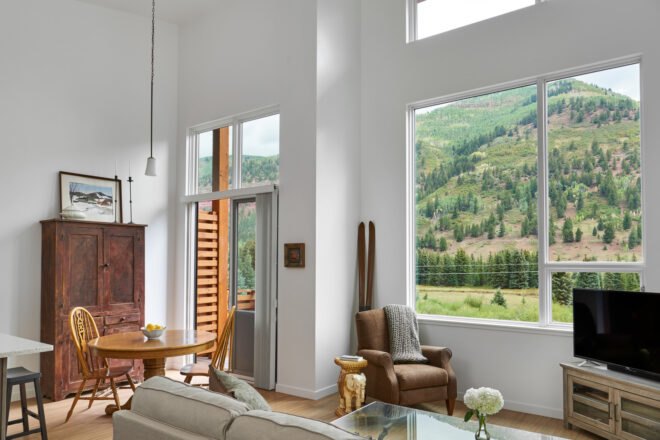 white room with tall ceilings and antique furniture