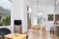white room with tall ceilings and small wood table
