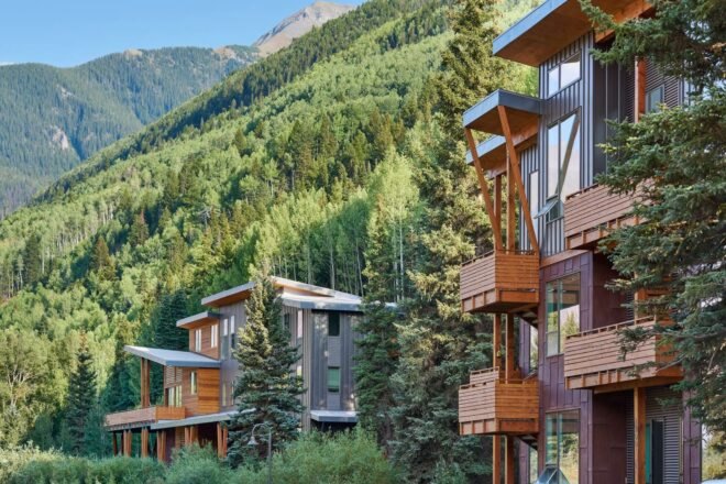cedar and metal buildings at bottom of a mountain