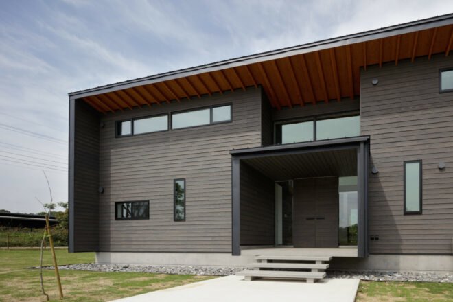 black timber building with a boxed entranceway