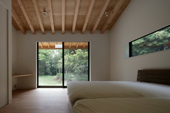 bedroom with two beds and large sliding glass door