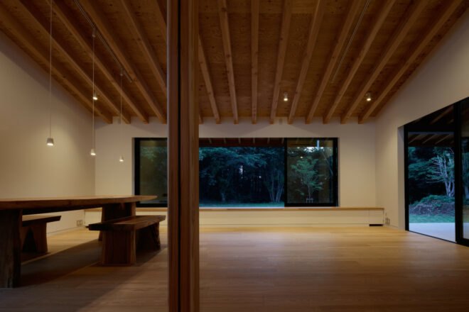 minimalist living area with white walls and wooden dining table