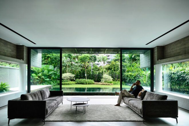 interior of home with large windows with sights of backyard pool and greenery