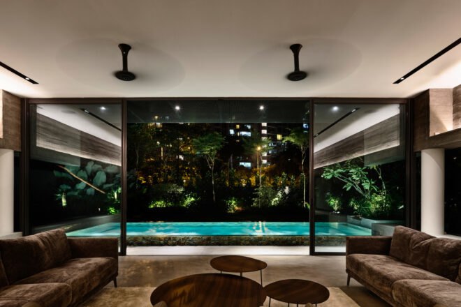 interior of home with large windows with sights of backyard pool and greenery