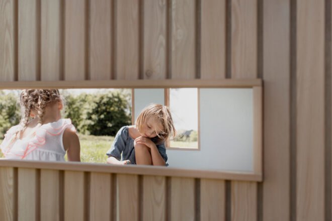 horizontal window with view of children playing inside