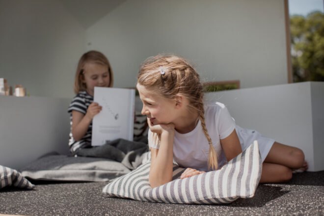 little girl lying on a pillow
