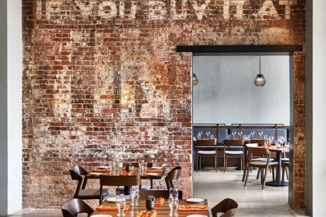 exposed brick with letter pressings decorate a restaurant's wall