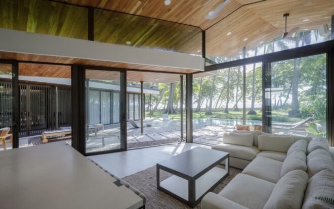 living area with wood ceilings and glass walls