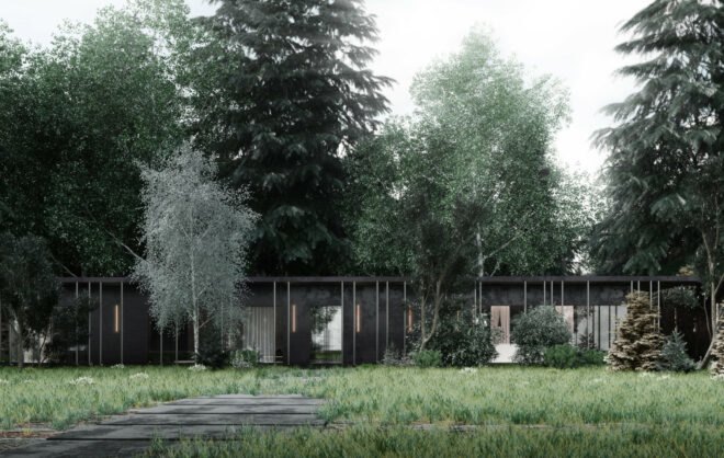low, elongated black cabin in a forest
