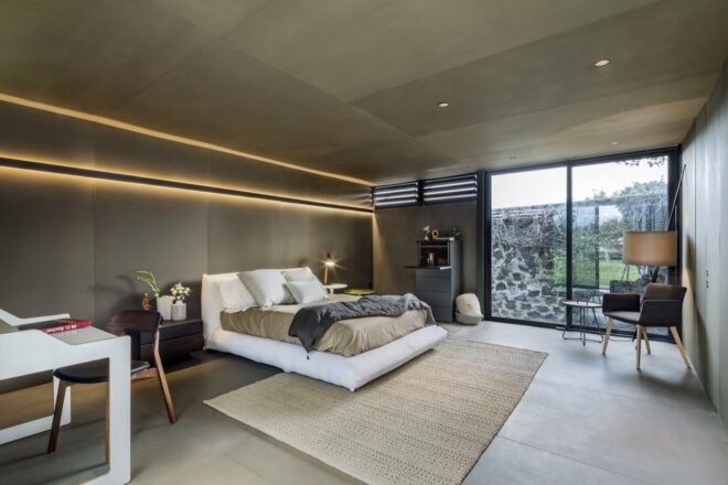 bedroom with large windows overlooking a yard