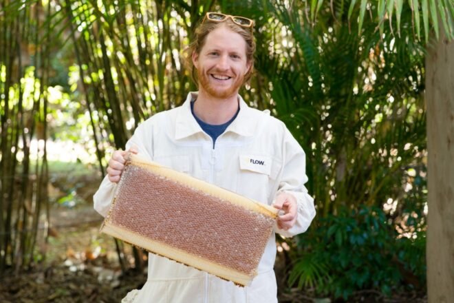 man holding beehive brood frames