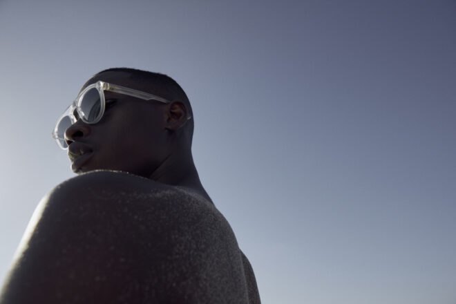 model wears clear sunglasses
