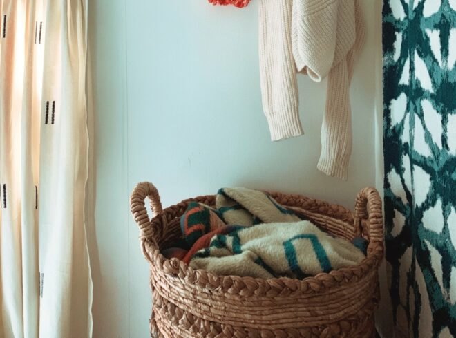 a wicker basket filled with clothes