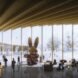 rendering of giant bunny sculptures inside curving building