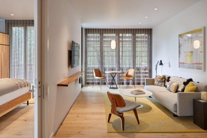 hotel room with living area with couch separated from bedroom