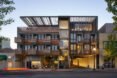 wood and glass hotel building lit up at night