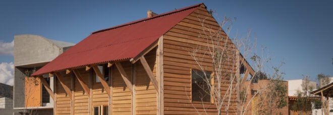 small timber home with red gabled roof