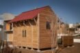 small timber home with red gabled roof