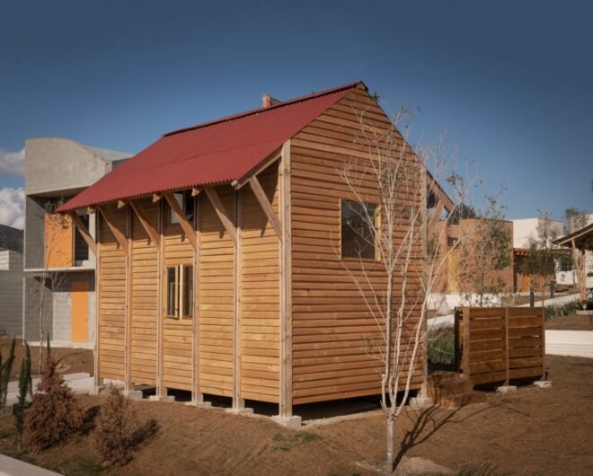 small timber home with red gabled roof