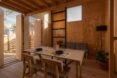 wood dining table facing a gray sofa