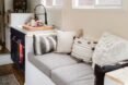 a small loveseat next to a kitchen area