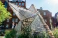 small shelter made out of recycled plastic bottles with triangular door opening upward