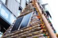 solar panels on outside of shelter made from plastic bottles