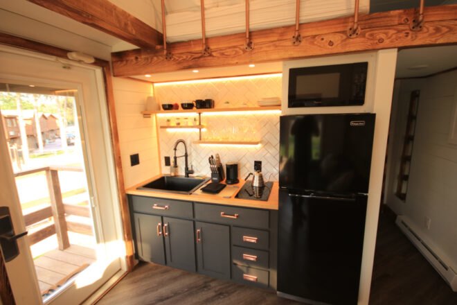tiny home kitchen with full-sized refrigerator