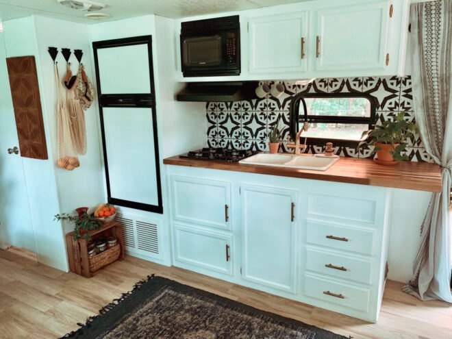 kitchen with black and white backsplash and white cabinets