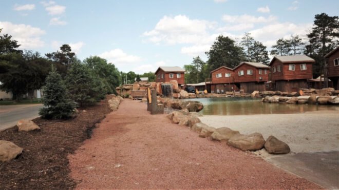 lagoon surrounded by tiny wood cabins