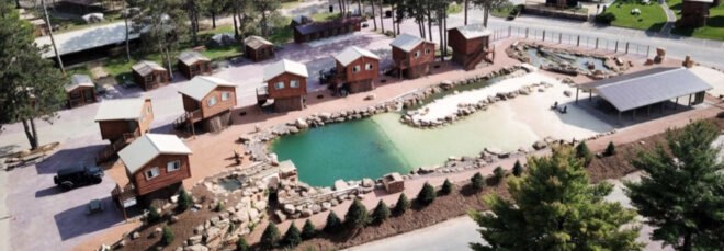wooden cabins surrounding a lagoon