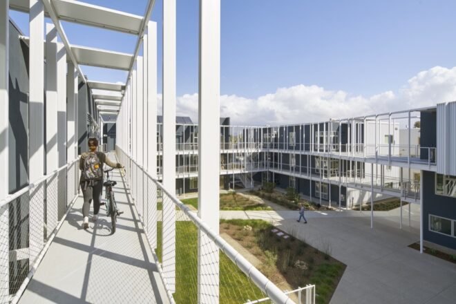 metal panel structure for student housing adorned with nearby trees and grass