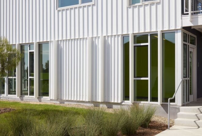 metal panel structure for student housing adorned with nearby trees and grass