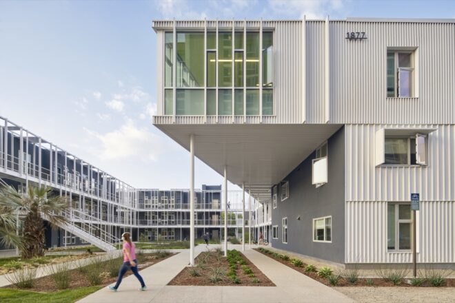 metal panel structure for student housing adorned with nearby trees and grass