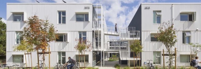 metal panel structure for student housing adorned with nearby trees and grass