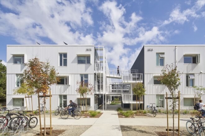 metal panel structure for student housing adorned with nearby trees and grass