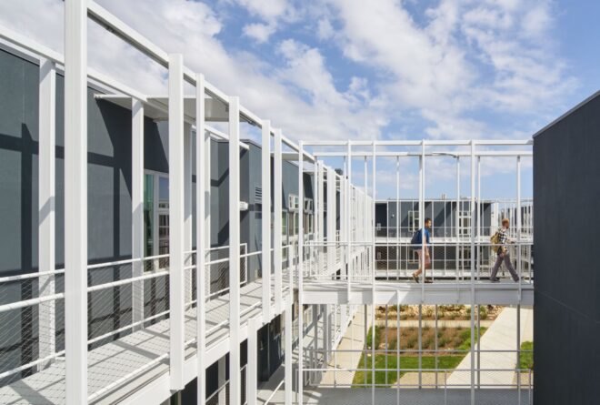 metal panel structure for student housing adorned with nearby trees and grass