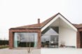 brick house with large ceiling to floor windows