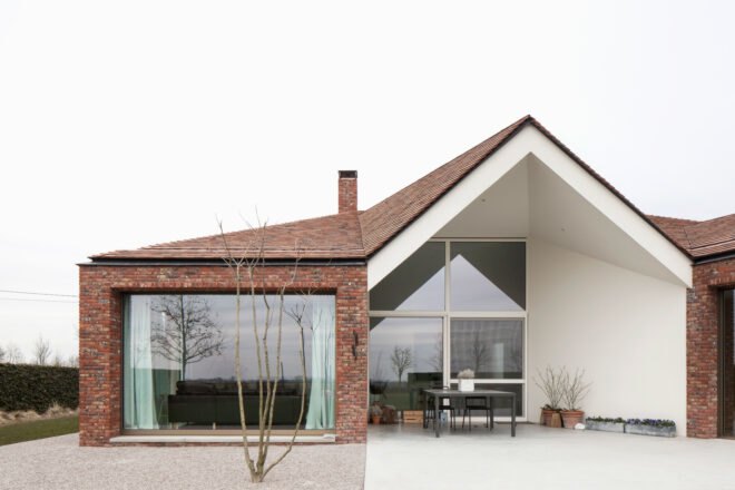 brick house with large ceiling to floor windows