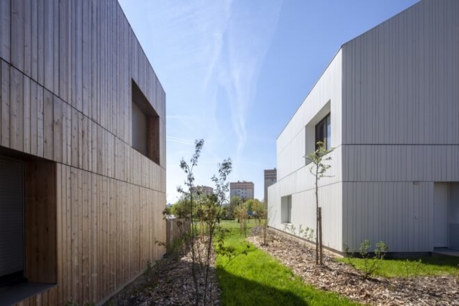 grass and trees adorn the areas in between the structures