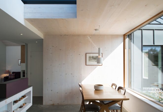 an interior dining space with large wood dining table