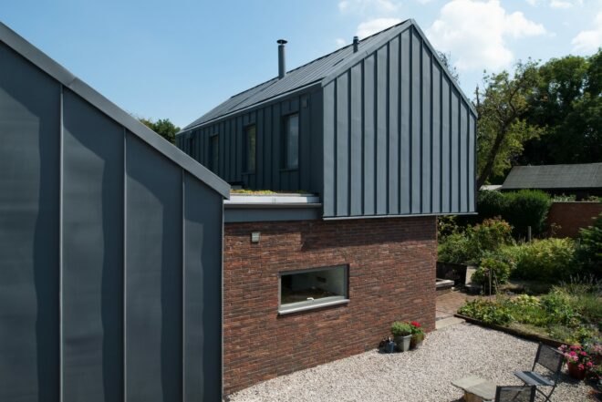 brick home with zinc gabled roof