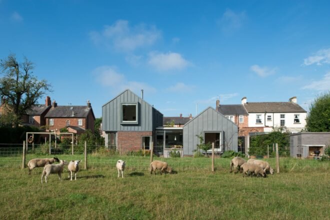 brick home with top extension with gabled roof