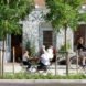 people sitting outside cafe at tables on top of rainwater-capturing sidewalk tiles