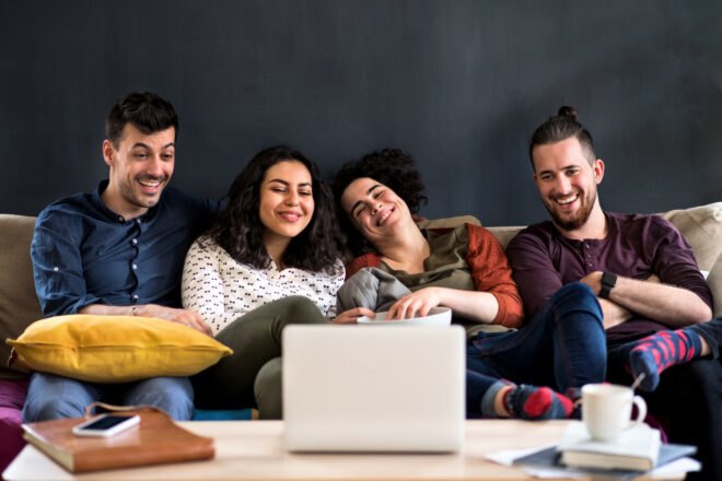 group of people watching movie on a couch