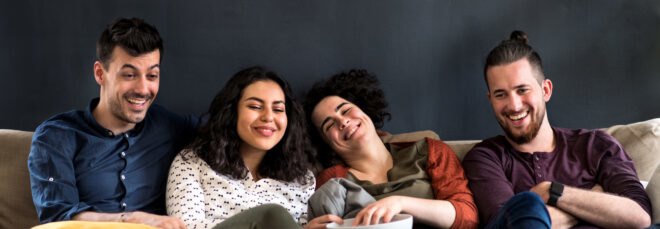 group of people watching movie on a couch