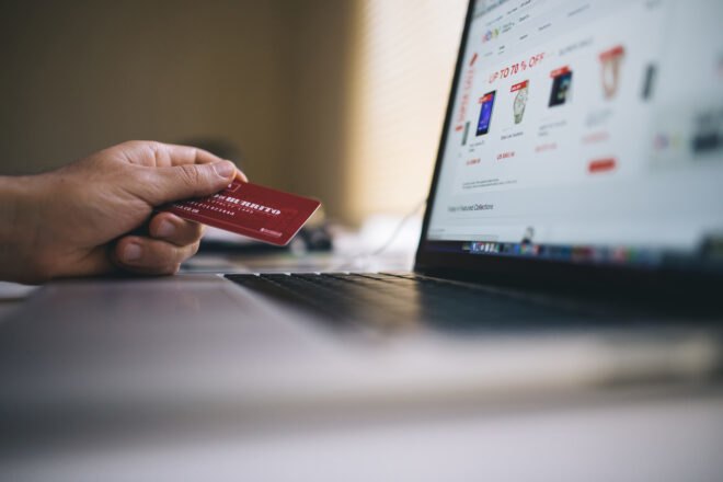 person holding a credit card for online shopping